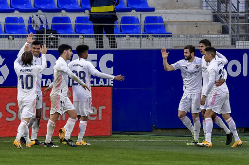 Varane double leads Madrid comeback win at last-place Huesca